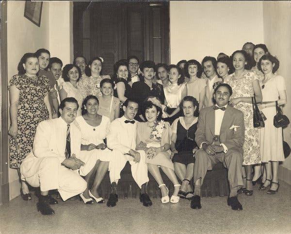 A group of people posing for a photo

Description automatically generated