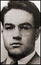 A person wearing glasses and a suit

Description automatically generated