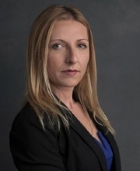 A person with blonde hair wearing a black jacket

Description automatically generated