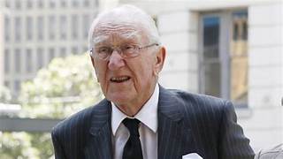 An old person in a suit and tie

Description automatically generated