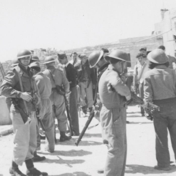 Fighters from Israel's pre-state militia occupying the village of Deir Yassin, April 1948.