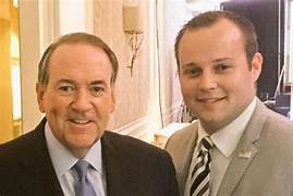 Two men in suits smiling

Description automatically generated