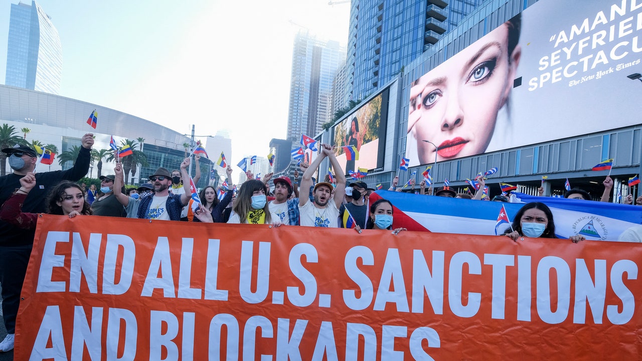 A group of people holding a banner

Description automatically generated