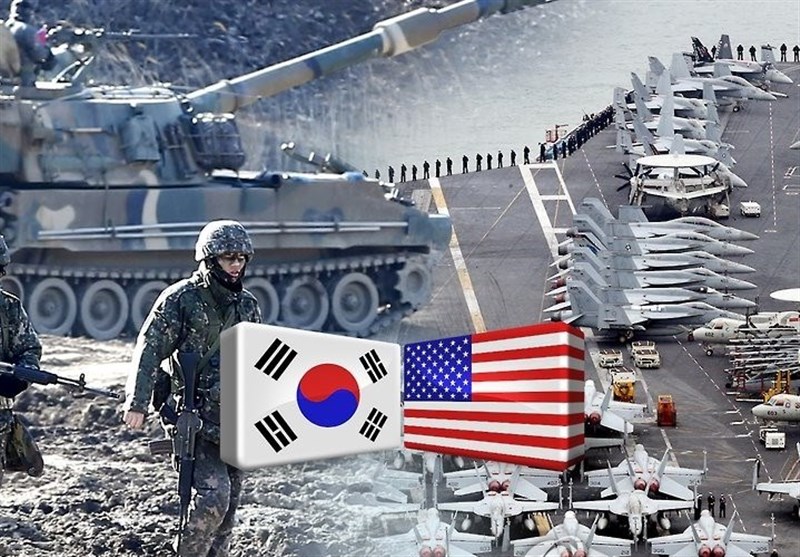 A military person standing on a road with military tanks and flags

Description automatically generated