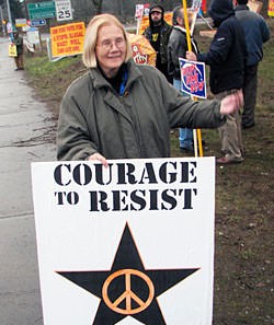 A person holding a sign

Description automatically generated