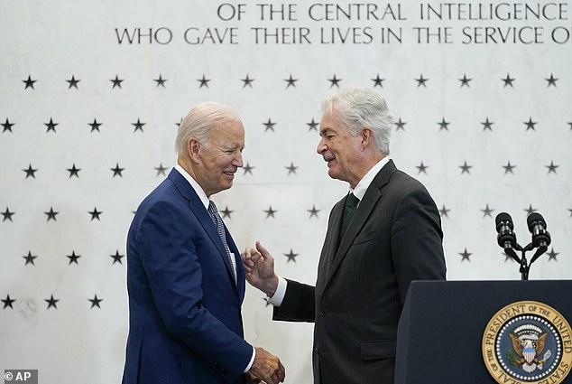 A person in suit shaking hands with another person in suit
Description automatically generated