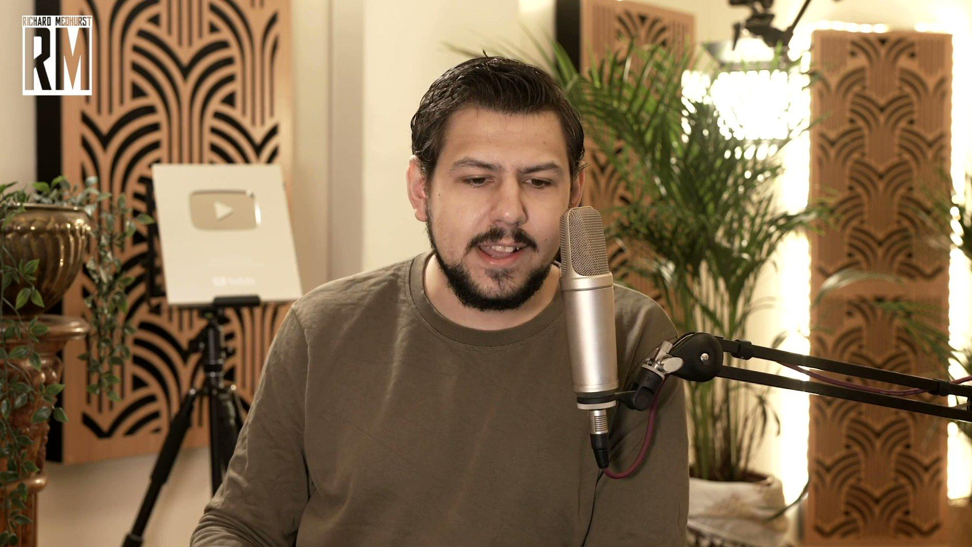 A person speaking into a microphone

Description automatically generated