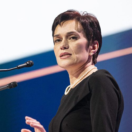 A person standing in front of a microphone

Description automatically generated