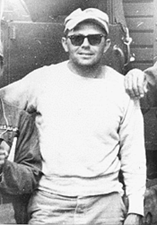 A person wearing sunglasses and a white shirt

Description automatically generated