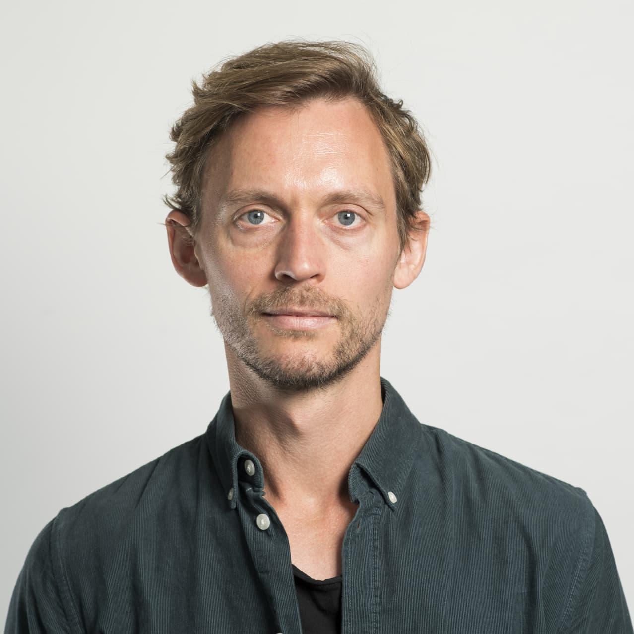 A person with a beard
Description automatically generated