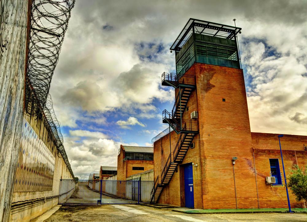 A prison building with a tower

Description automatically generated