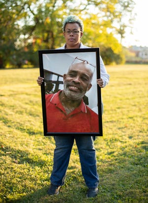 Jada McDaniel holds a portrait of her brother, Michael McDaniel, who died Feb. 6, 2021 after a violent clash with guards at the Correctional Reception Center.