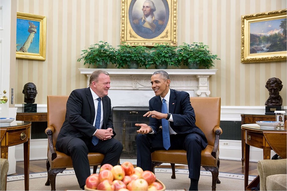 A couple of men sitting in chairs

Description automatically generated