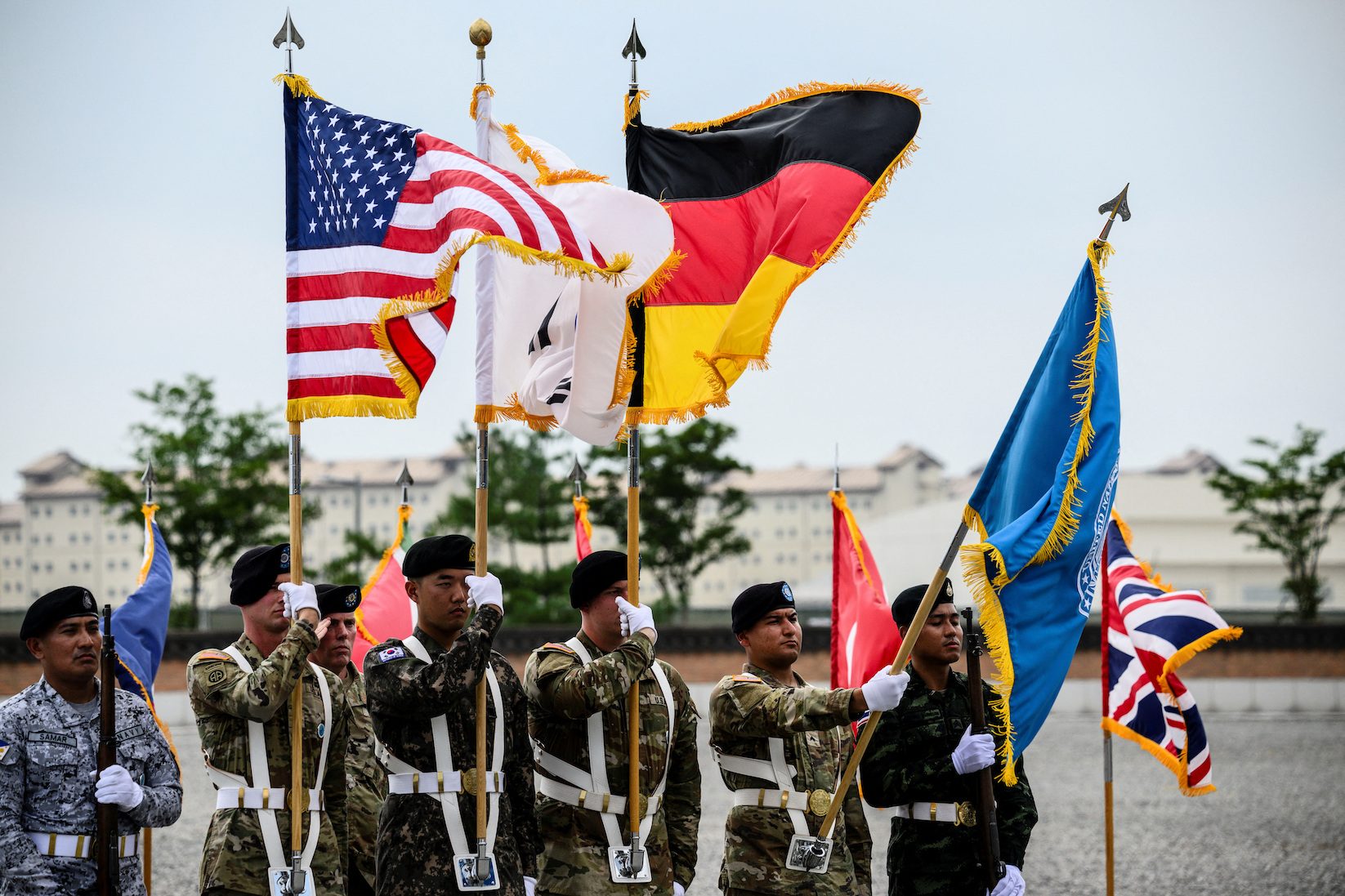 A group of soldiers holding flags

Description automatically generated