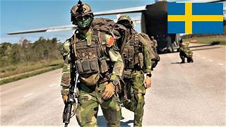 A group of soldiers walking on a road Description automatically generated