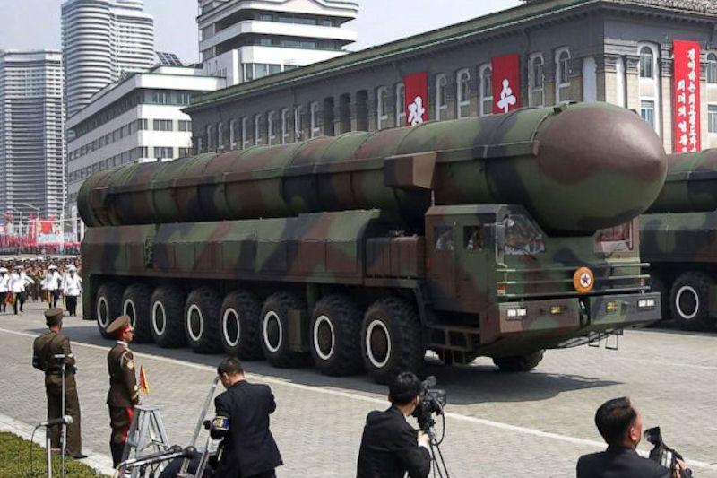A military vehicle with a missile on the side

Description automatically generated