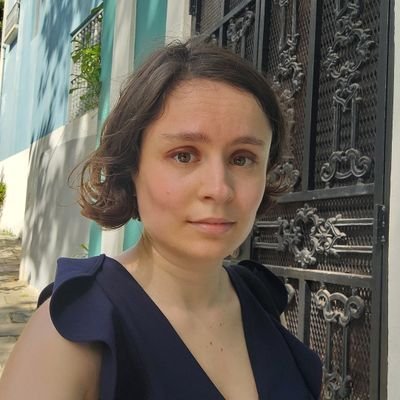 A person in a blue dress

Description automatically generated
