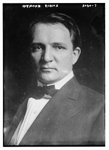 A person in a suit and bow tie
Description automatically generated