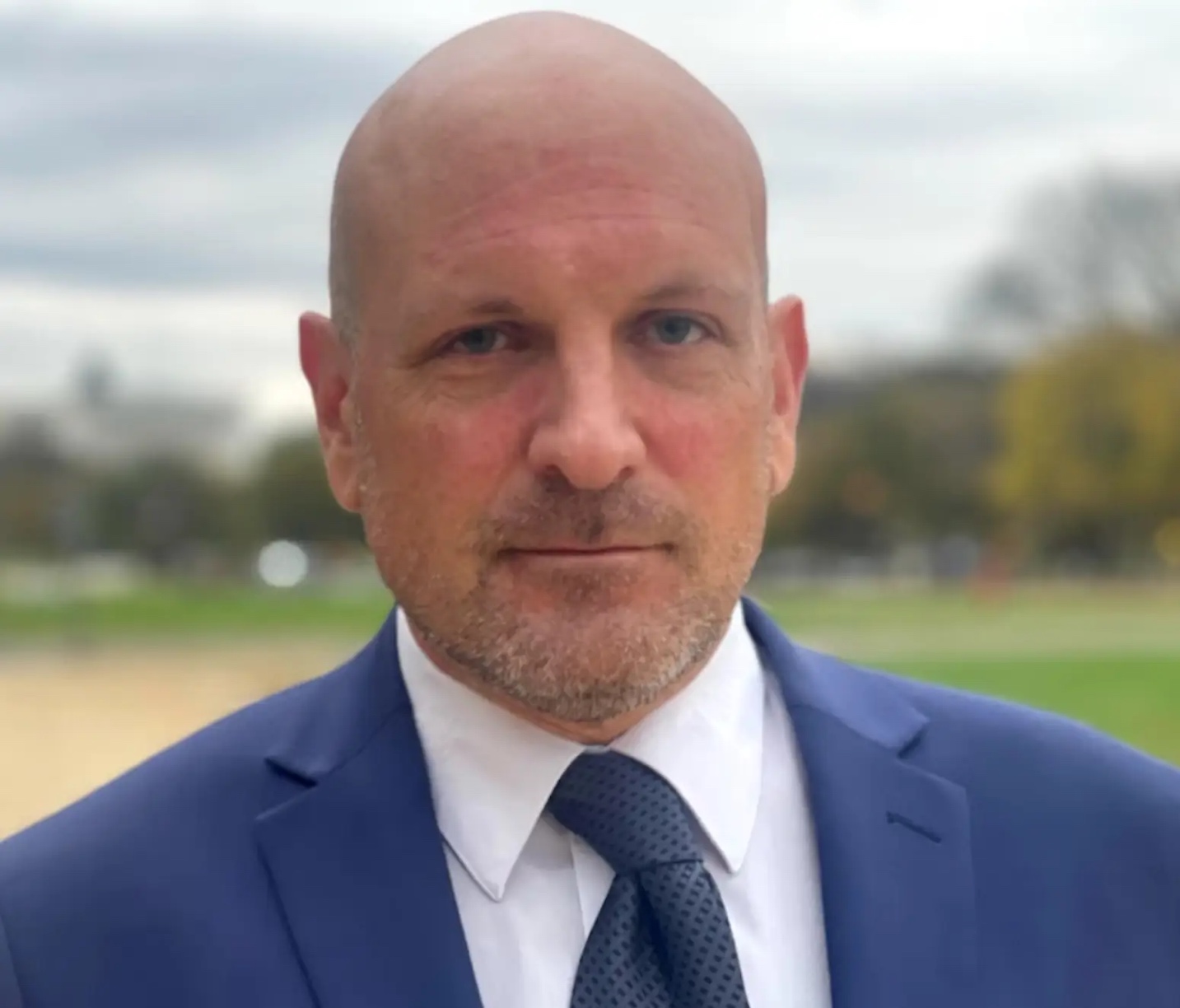 A person in a suit
Description automatically generated