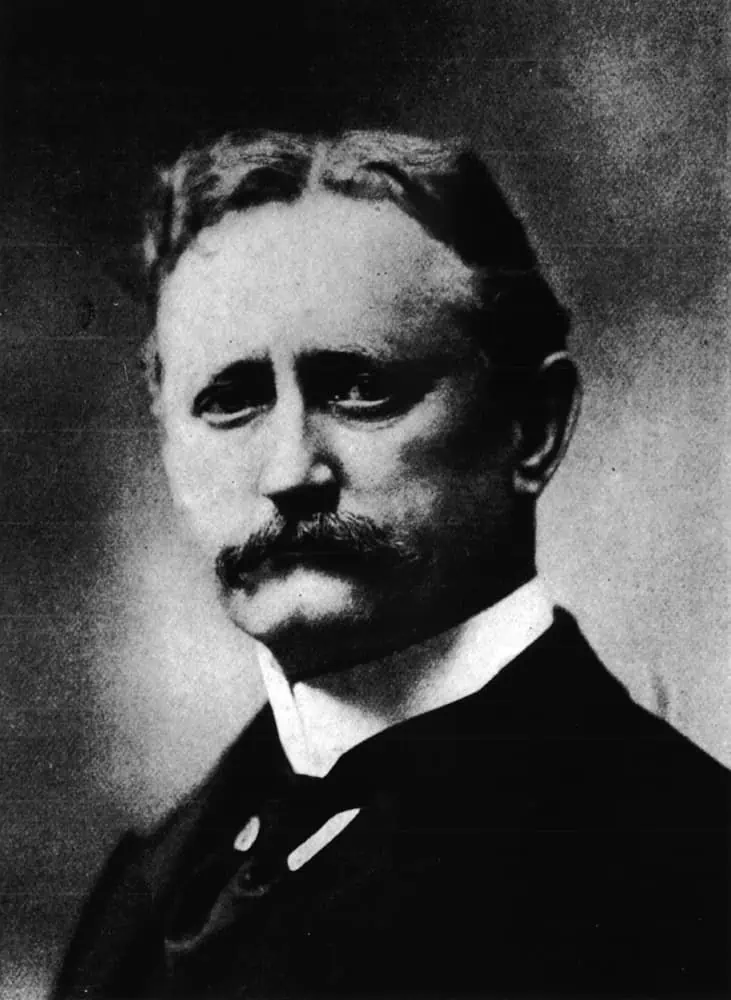 A person with a mustache
Description automatically generated