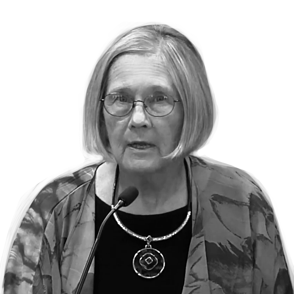 A person with glasses and a necklace Description automatically generated