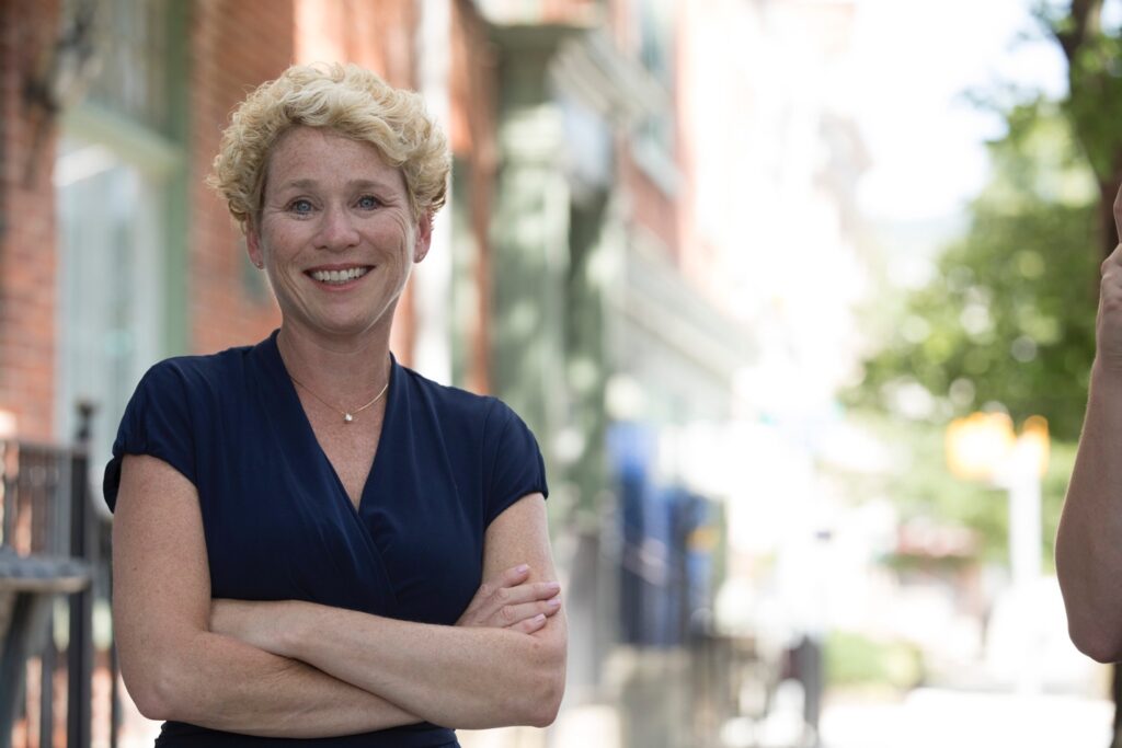 A person with her arms crossed

Description automatically generated
