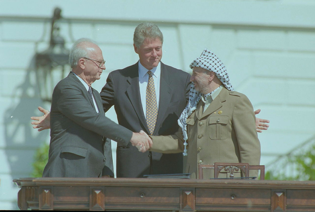 A few men shaking hands Description automatically generated