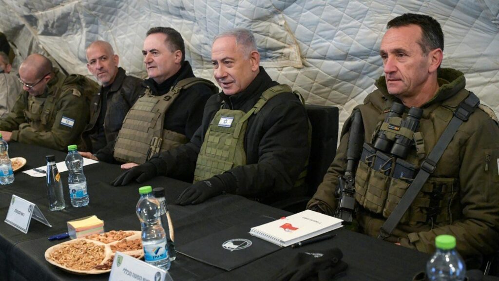 A group of men sitting at a table Description automatically generated