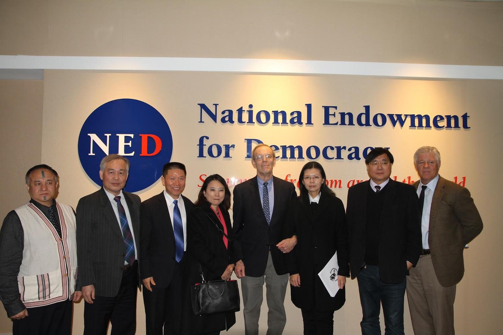 A group of people standing in front of a sign

AI-generated content may be incorrect.