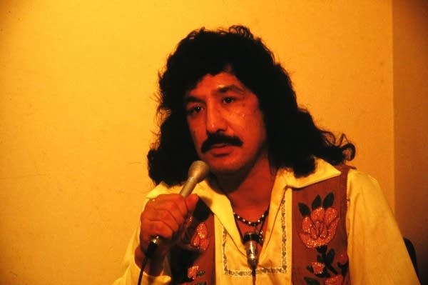 A man holds a microphone 