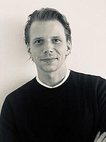 A person in a black shirt
Description automatically generated