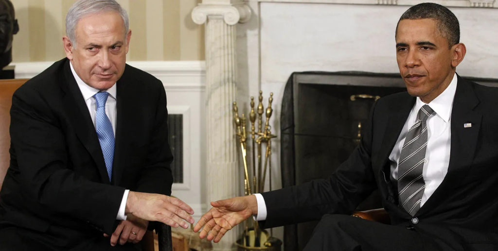 A person in a suit shaking hands with another person Description automatically generated