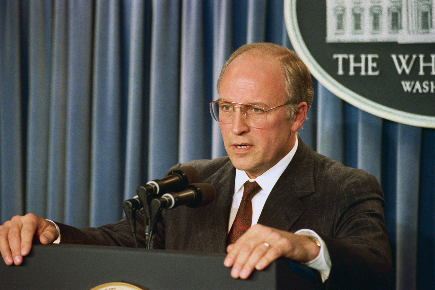 A person speaking at a podium
Description automatically generated