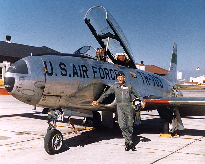 A person standing next to a jet

Description automatically generated