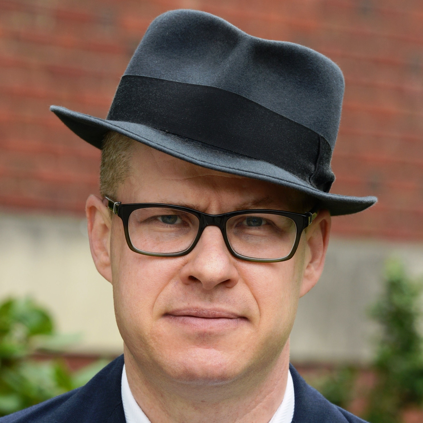 A person wearing a hat and glasses

Description automatically generated