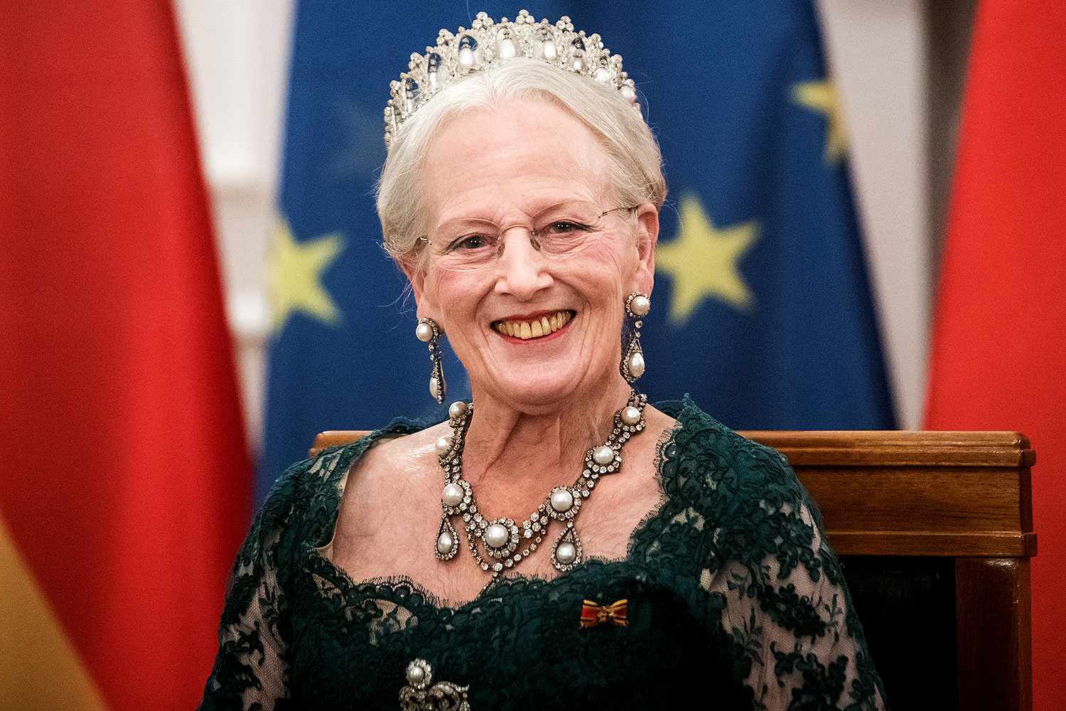 A person wearing a tiara and earrings
Description automatically generated