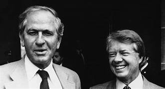 A couple of men smiling

Description automatically generated
