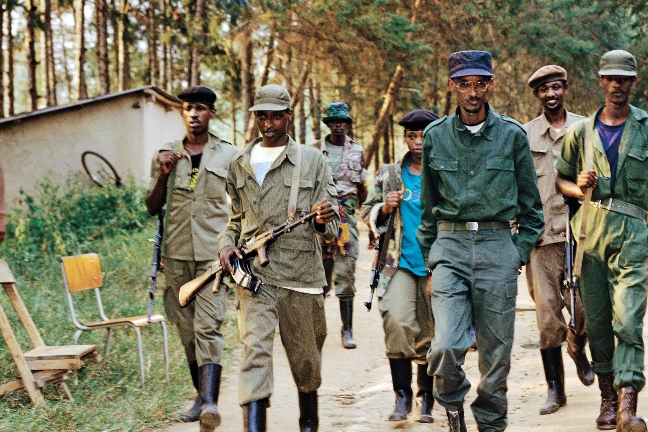 A group of men in military uniforms walking on a path<br><br>Description automatically generated