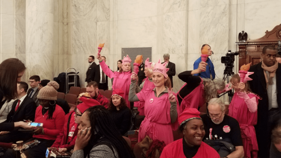 A group of people in pink outfits

AI-generated content may be incorrect.