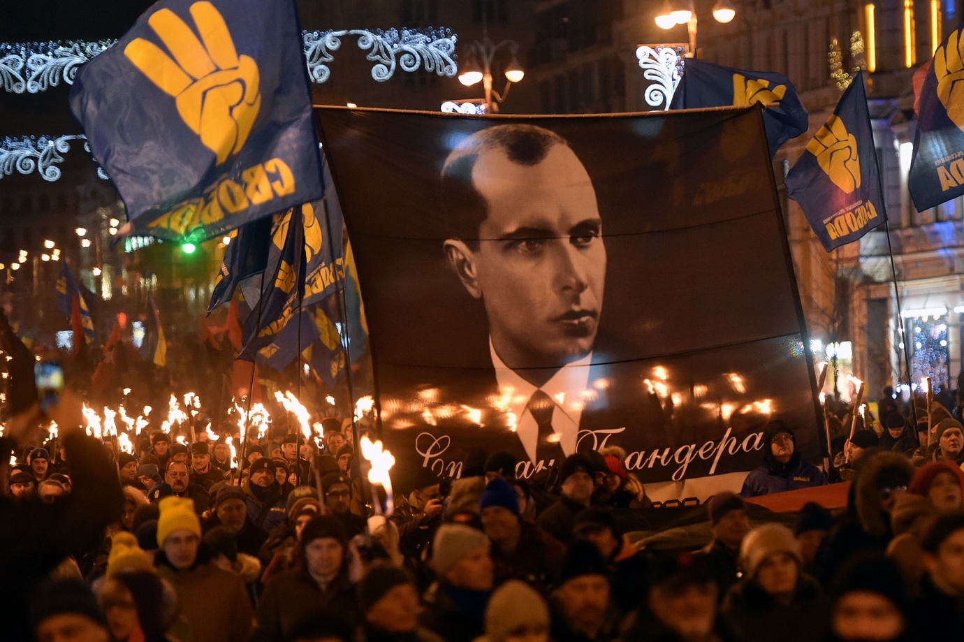A group of people marching in a street
Description automatically generated