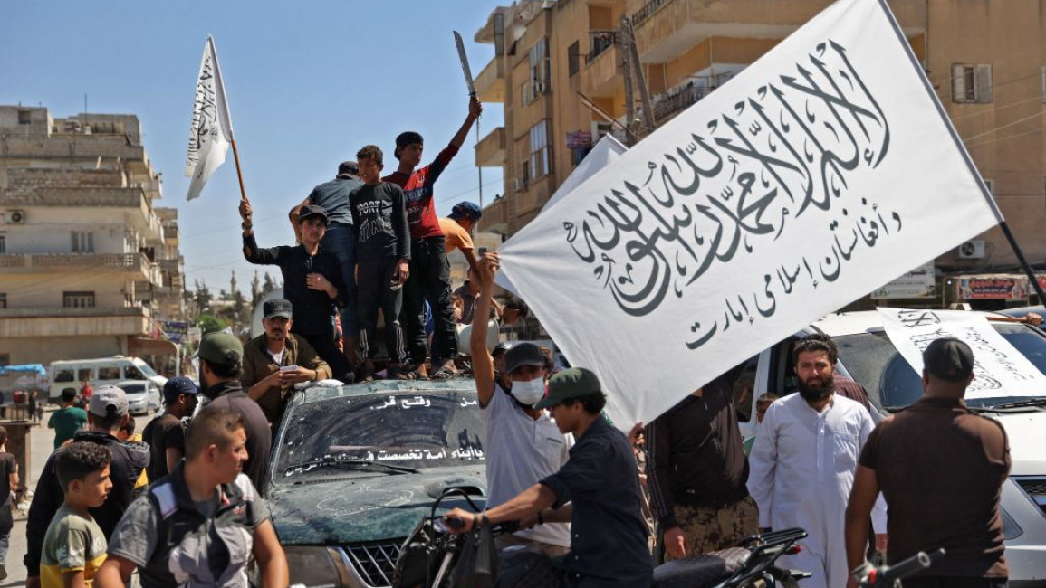 A group of people protesting in a street
Description automatically generated
