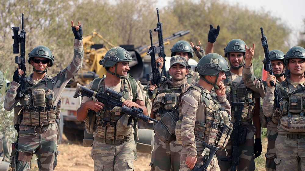 A group of soldiers holding guns
Description automatically generated