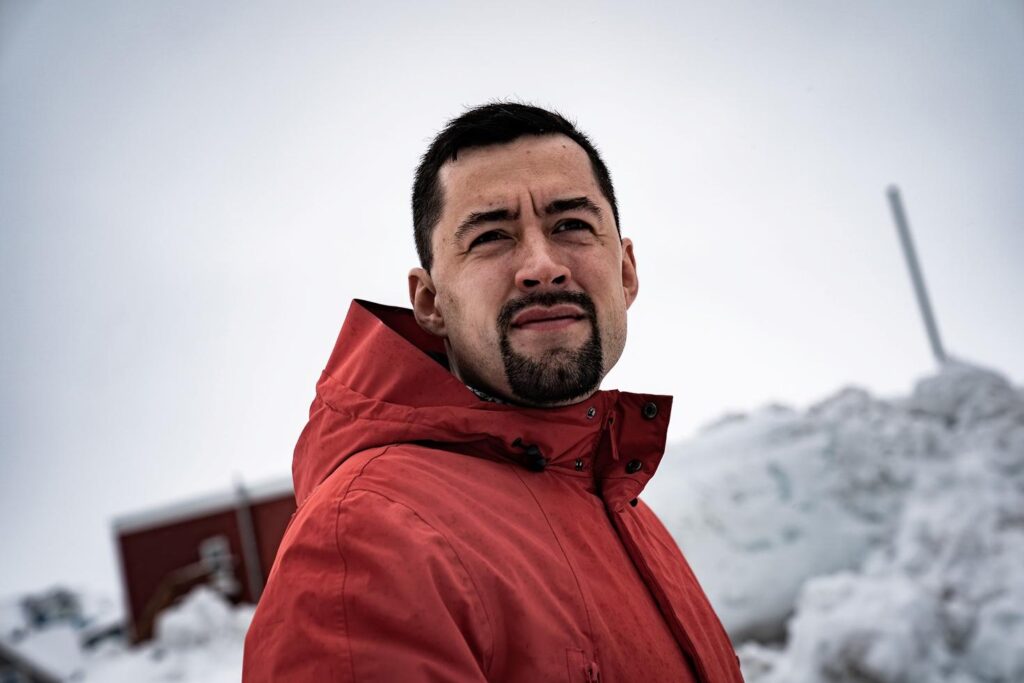 A person in a red coat AI-generated content may be incorrect.