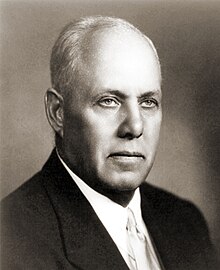 A person in a suit and tie
Description automatically generated