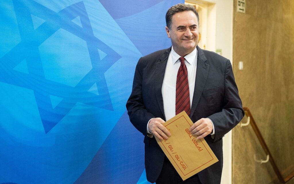 A person in a suit holding a certificate Description automatically generated