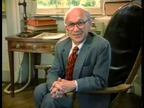 A person in a suit sitting in a chair

Description automatically generated