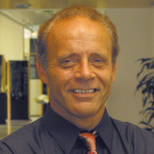 A person smiling at the camera Description automatically generated