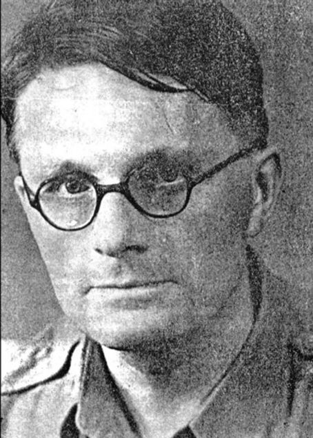 A person wearing glasses and a military jacket

Description automatically generated