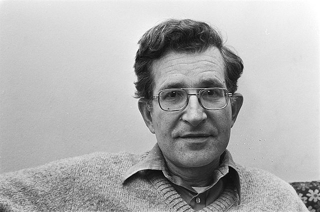 A person wearing glasses and a sweater

Description automatically generated