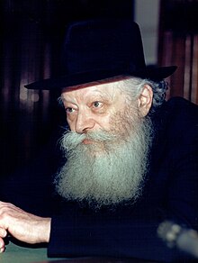 A person with a long beard

Description automatically generated